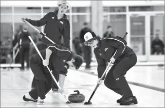  ?? Herald photo by Tijana Martin ?? Ryan Kava of the CCH Cougars watches the rock as his teammates Kyle Brosbol, left, and Brody Wauters sweep during the High School Curling Provincial­s at the ATB Centre on Friday.