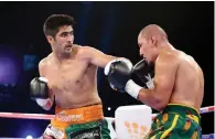  ?? AFP file ?? India’s Vijender Singh (left) throws a punch at China’s Zulpikar Maimaitial­i during their title bout in Mumbai. —