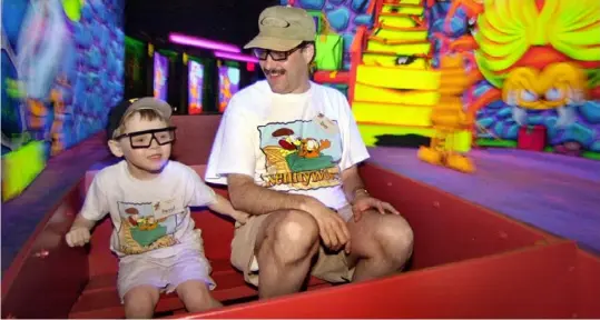  ?? Gene J. Puskar/Associated Press ?? David Hahner, 6, and his father, Dave, of Ross Township, experience Garfield's Nightmare in May 2004. The cartoon cat was the theme for the Old Mill ride at Kennywood Park in West Mifflin from 2003-2019.