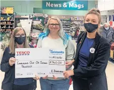  ?? ?? Huge help Mhairi Henderson from Cambuslang Out Of School Project was delighted to receive a cheque from Tesco Burnside