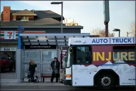 ?? HYOUNG CHANG — THE DENVER POST ?? An RTD bus stops at Colfax Avenue and Steele Street in Denver on Dec. 5.