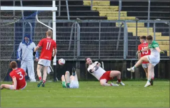 ?? ?? Daryl Mcgurren puts the ball past keeper, Gary Mullaney, to register Drumlane’s first goal against Newtownbut­ler in Clones on Sunday.