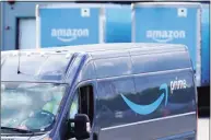  ??  ?? An Amazon Prime logo on the side of a delivery van as it departs an Amazon Warehouse location in Dedham, Mass. Amazon, is one of the few companies that has thrived during the coronaviru­s outbreak. People have turned to it to order groceries, supplies and other items online, helping the company bring in record revenue and profits between April and June.