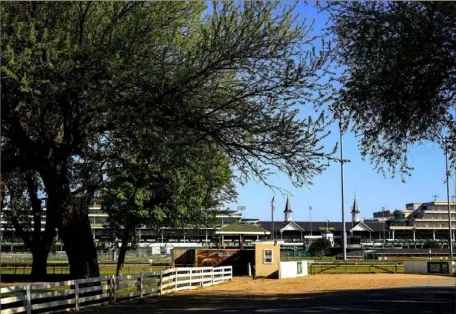  ?? Andy Lyons / Getty Images ?? A view of the twin spires and empty grandstand from the barn area at Churchill Downs. On any other Derby day, this area would be teeming with contenders, with trainers, with jockeys and with fans soaking in the Americana that is the race.