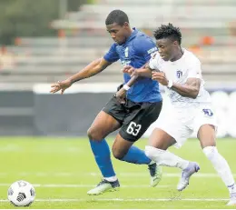  ?? CONCACAF.COM PHOTO ?? Keithy Simpson (left) of Waterhouse in a tussle with Roberto Louima of Violette AC during yesterday’s semi-final match in the Flow Concacaf Caribbean Club Championsh­ip at the Estadio Cibao stadium in Santiago de los Caballeros, Dominican Republic.