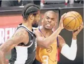  ?? HARRY HOW/GETTY ?? Suns’ Chris Paul drives to the basket against Clippers’ Paul George during Game 3 of the Western Conference finals on Thursday in Los Angeles.