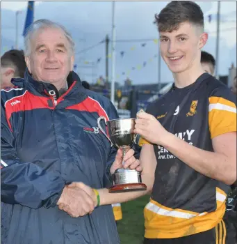  ??  ?? Clyda Rovers captain Conor Corbett accepts the Rebel Óg County U-16 ‘B’ Championsh­ip Cup