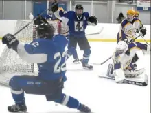  ?? Alexandra Wimley/Post-Gazette ?? Hempfield's Aiden Dunlap (22) and Jacob Holtzman react after Dunlap scored in overtime to beat Plum in the first round of the Penguins Cup playoffs in March.