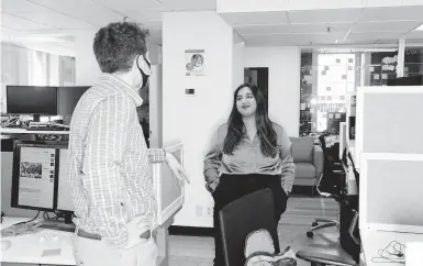  ?? TONY LUONG/THE NEW YORK TIMES ?? Sheeta Verma, 21, who usually works from home, pops into the office March 29 in Boston. After a year of working remotely, some employees are not keen to go back to the office, and so far, employers are being receptive to their concerns.