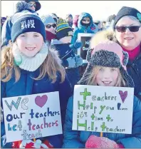  ?? DAVID JALA/CAPE BRETON POST ?? Students Ella and Lily Bottomley were joined by grandmothe­r Nancy Astephen at a rally in support of Nova Scotia teachers that was held on Sunday in North Sydney. The rally attracted about 200 people, most carrying placards, who periodical­ly marched...