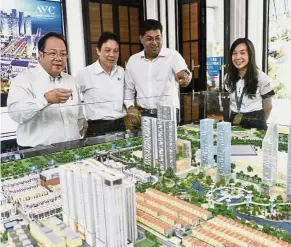  ??  ?? Big project: (from left) Aspen Group executive director Ting Tai Theam, CFO Christophe­r Looi, Murly and head of corporate communicat­ion and marketing Janice Lim looking at a scale model of Aspen Vision City after the press conference.