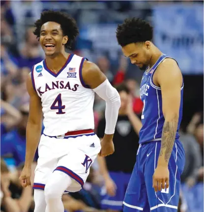  ??  ?? Kansas’ Devonte’ Graham celebrates as he runs past Duke’s Gary Trent Jr. in the final seconds of overtime Sunday.