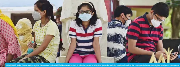  ??  ?? ALLAHABAD, India: People wait to register themselves for the COVID-19 coronaviru­s test at a testing center in Allahabad yesterday as India overtook Brazil as the country with the second-highest number of coronaviru­s infections. — AFP