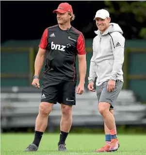  ??  ?? Scott Robertson, left, and Ryan Crotty watch the Crusaders train ahead of the game against the Highlander­s in Southbridg­e tomorrow evening. GETTY IMAGES