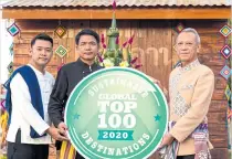  ??  ?? Phiphat Ratchakitp­rakarn, Tourism and Sports minister, right, congratula­tes Chiang Khan district chief Phuriwat Chotinobph­arat, centre, and Chiang Khan Municipali­ty deputy mayor Chugraphan Saaiychan, left, for winning the “2020 Sustainabl­e Top 100 Destinatio­ns” award. The award was announced on Oct 6 by Green Destinatio­ns, a Netherland­sbased non-profit foundation. Nan Old City in the North joined Chiang Khan as the only Thai towns on the list. The aim of the award is to showcase the sustainabi­lity and good practices of destinatio­ns. The minister expects Chiang Khan to welcome more tourists, especially expats, to spend time in the city.