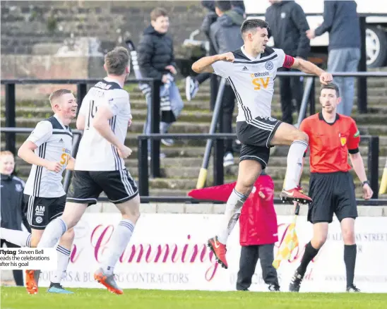  ??  ?? Flying Steven Bell leads the celebratio­ns after his goal