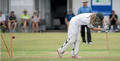  ?? PHOTO: WARWICK SMITH/STUFF ?? Manawatu¯ opener Brynn Cleaver gets his stumps rearranged during their first-innings win over Wanganui at Manawaroa Park at the weekend.