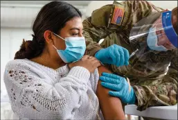  ?? DANIEL A. VARELA/MIAMI HERALD ?? Speech pathologis­t Hannah Sielk gets vaccinated against COVID by U.S. Army Corporal Powell at Miami Dade College North Campus in Florida on March 6.