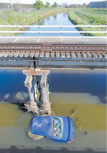  ?? Photos / NZME ?? Police say it’s lucky no one died when the car crashed into the Karamu Stream.