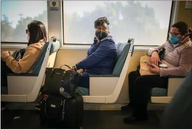  ?? RAY CHAVEZ — STAFF PHOTOGRAPH­ER ?? Jules Means, 69, center, rides a train from the MacArthur BART station to Antioch on Friday. Means, who lives in Antioch, commutes hours each day to attend classes at UC Berkeley because she can't afford housing prices closer in.