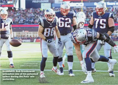  ?? STAFF PHOTO BY CHRISTOPHE­R EVANS ?? SLAMMED: Rob Gronkowski unleashes one of his patented spikes during the Pats’ win yesterday.