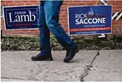  ?? Andrew Harrer / Bloomberg ?? Conor Lamb, the Democratic candidate, was battling Republican Rick Saccone for a seat in the U.S. House on Tuesday. Lamb and Saccone are competing in Pennsylvan­ia’s 18th District, which President Donald Trump won by almost 20 points in 2016.