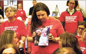  ?? Christian Abraham / Hearst Connecticu­t Media ?? Erin Bond, of Bethel, holds a photo of her niece Emily Todd, who was murdered in 2018, during a special statewide event hosted by Moms Demand Action for Gun Sense in America at the Margaret Morton Government Center in Bridgeport on Feb. 8.