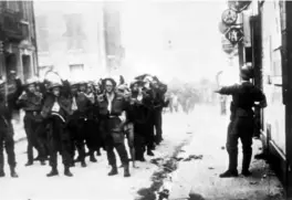  ??  ?? Left: Captured Canadian soldiers march through Dieppe, France.
Right: Canadian soldiers, some of them wounded, arrive back in England following the failed raid.