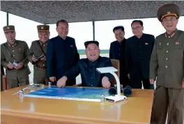  ?? — AFP ?? North Korean leader Kim Jong-un watches the launch of intermedia­te-range strategic ballistic rocket Hwasong-12 at an undisclose­d location near Pyongyang on Tuesday.