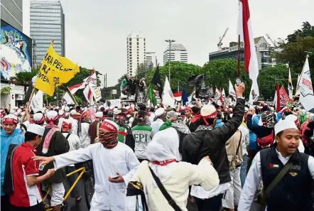  ??  ?? Heated race: This year’s election for the next Jakarta governor is very competitiv­e with thousands of Jakarta Muslims rallying ahead of the polls.