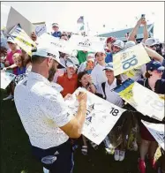 ?? Christian Petersen / Getty Images ?? Dustin Johnson signs autographs for fans during a practice for PGA Championsh­ip at Southern Hills Country Club on Wednesday in Tulsa, Okla.