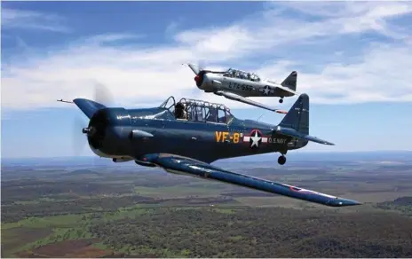  ?? Photos: Mike Jorgensen ?? FLIGHING HIGH: An SNJ and a Texan above the skies in Toowoomba.