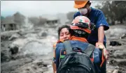  ?? RODRIGO ABD / ASSOCIATED PRESS ?? A rescue worker comforts Damaris Toma, 24, who lost her 6-yearold daughter Emily in last Sunday’s eruption, in San Miguel Los Lotes, Guatemala, on Saturday.