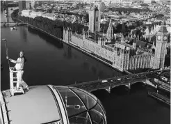  ?? Luke Mac Gregor
, Reuters ?? Torch bearer Amelia Hempleman-Adams stands on top of the London Eye as part of the torch relay on Sunday.