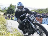  ??  ?? Fast as she goes . . . Kevin Ryan, of Greymouth, accelerate­s his 1966 Triumph MLC 800 up the hill in the Burt Munro Challenge’s hill climb on the Bluff.