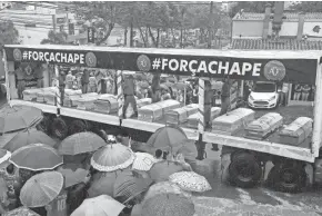  ?? ASSOCIATED PRESS ?? Coffins with the remains of Chapecoens­e soccer team members who died in a plane crash are taken to the team’s stadium for a memorial in Chapeco, Brazil, on Saturday.