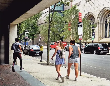  ?? Hearst Connecticu­t Media file photo ?? A jogger and pedestrian­s pass by the Yale Center for British Art in New Haven on July 2. New Haven is a key part of Connecticu­t’s economy, which added 20,400 jobs in August 2020, according to state Department of Labor data.