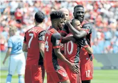  ?? JON BLACKER/THE CANADIAN PRESS ?? Toronto FC’s Sebastian Giovinco celebrates with teammates including Jozy Altidore, right, after scoring against New York City FC during the first half of Toronto’s 4-0 win on Sunday.