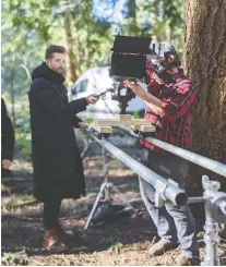  ??  ?? Production designer and composer Cayne Mckenzie, left, and director of photograph­y Joseph Schweers are seen working on SARS-COV-2, which is among the film shorts commission­ed by Reel Canada and Netflix Canada.