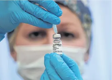  ?? REUTERS ?? A nurse prepares Russia’s ‘Sputnik-V’ vaccine against the coronaviru­s disease for inoculatio­n in a post-registrati­on trial stage at a clinic in Moscow.