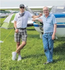  ??  ?? Craig Daniels, left, and Geoff Grenville in front of their Cessna 172 in the aircraft camping area in Oshkosh, Wis.