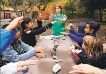  ?? PHOTOS BY GARY REYES — STAFF PHOTOGRAPH­ER ?? At the Youth Science Institute at Alum Rock Park in San Jose, instructor Sarah Lofgren demonstrat­es the layers of the earth with fourth-grade students from George Mayne Elementary School in Alviso.