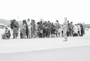  ?? Andreas Rentz / Getty Images ?? Evacuees from Afghanista­n wait to board a military plane at Ramstein Air Base in Germany, one of the main preliminar­y destinatio­ns for evacuees leaving Afghanista­n on U.S. military flights.