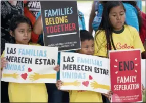  ?? THE ASSOCIATED PRESS ?? Children hold signs during a June 1 demonstrat­ion in front of the Immigratio­n and Customs Enforcemen­t offices in Miramar, Fla. The Trump administra­tion’s move to separate immigrant parents from their children on the U.S.-Mexico border has turned into a...