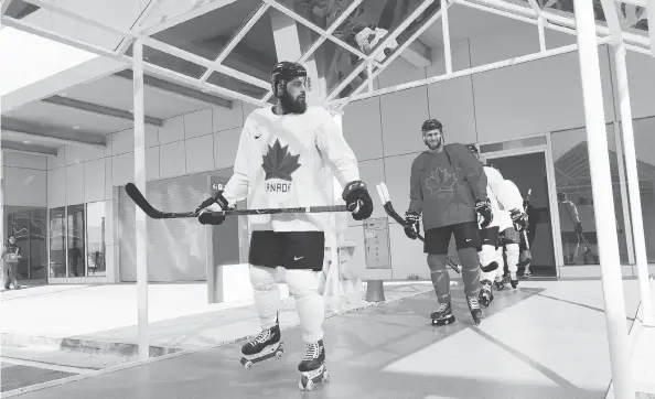  ?? BRUCE BENNETT/GETTY IMAGES ?? Team Canada’s Brandon Kozun and teammates rollerblad­e to practice ahead of the 2018 Winter Olympics at the Gangneung hockey training venue on Friday.