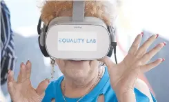  ??  ?? Nidia Silva samples a virtual reality experience in the Little Havana neighborho­od of Miami, Florida. The VR Genie project uses virtual reality to fulfill seniors’ wishes through immersive technology. — AFP