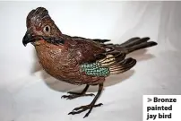  ??  ?? > Bronze painted jay bird