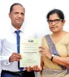  ??  ?? Ninewells Hospital General Manager Tharanga Weerasuriy­a receiving the certificat­e of accreditat­ion from SLAB Conformity Assessment Director and CEO Chandrika Thilakarat­ne