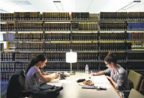  ?? Michael Short / Special to The Chronicle ?? Jeanne Briand (left) and Geraldine Gonzalez study for the bar exam in the UC Hastings College of the Law library in S.F. in March. After the latest test, 4,236 applicants are eligible to join the ranks of the state’s 189,000 practicing lawyers.