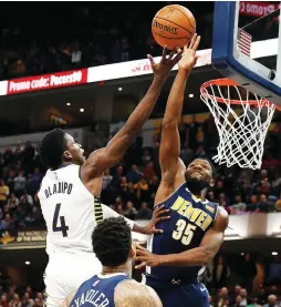  ?? (Reuters) ?? INDIANA PACERS guard Victor Oladipo (4) has his shot blocked by Denver Nuggets defender Kenneth Faried during the fourth quarter on Sunday night. Oladipo had the last laugh, however, as his career-high 47-point performanc­e carried the Pacers to a...